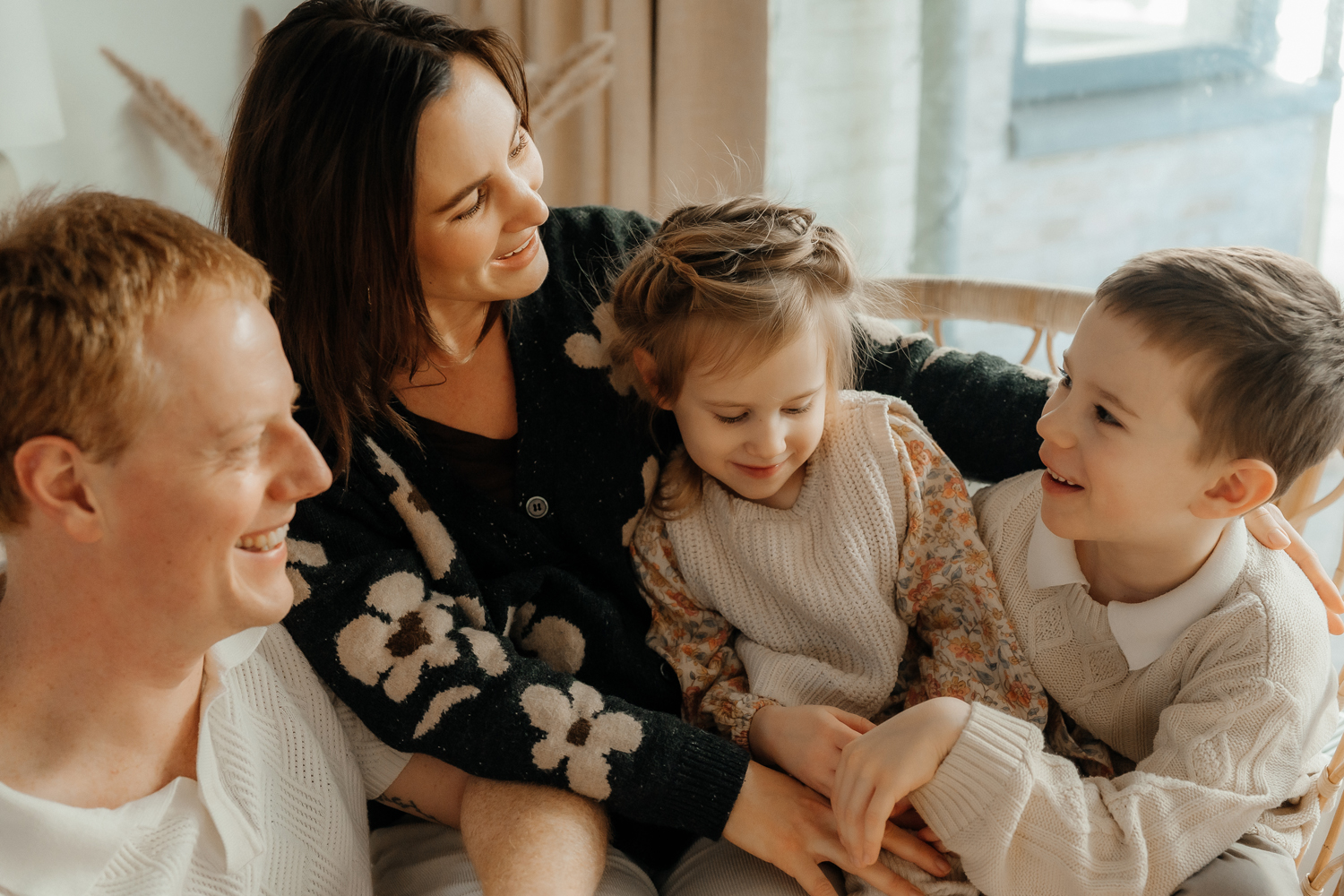 Lifestyle family photography showing a family interacting naturally, captured in soft light and a timeless style.