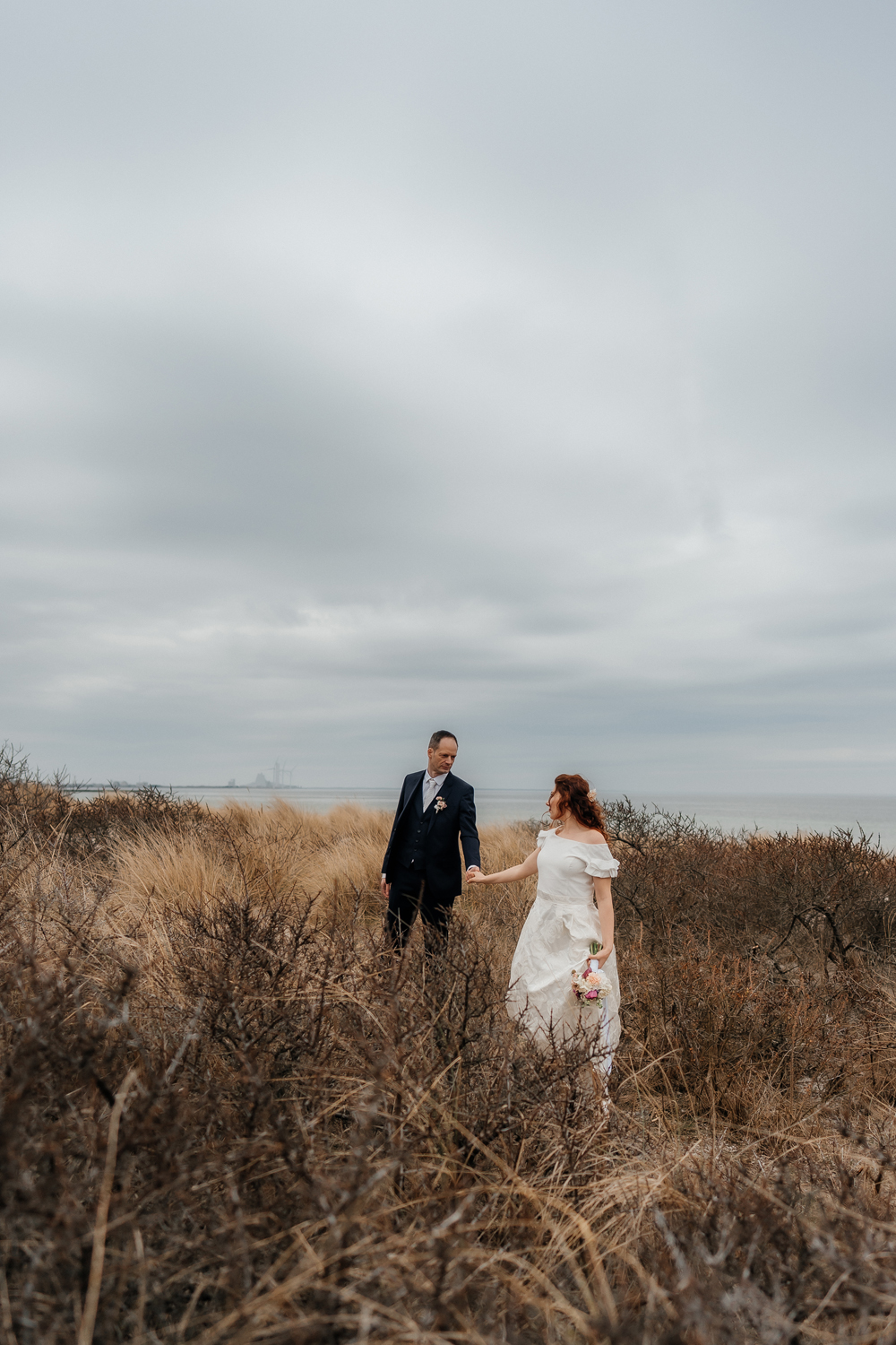 Intimate wedding at the beach in countryside of Copenhagen focused on real emotions, connection, and love. Wedding photographer in Copenhagen with a documentary style.