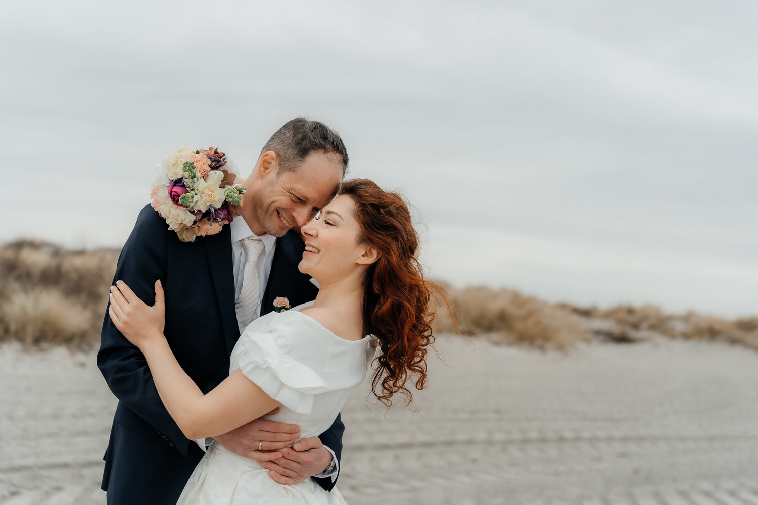 Intimate wedding at the beach in countryside of Copenhagen focused on real emotions, connection, and love. Wedding photographer in Copenhagen with a documentary style.