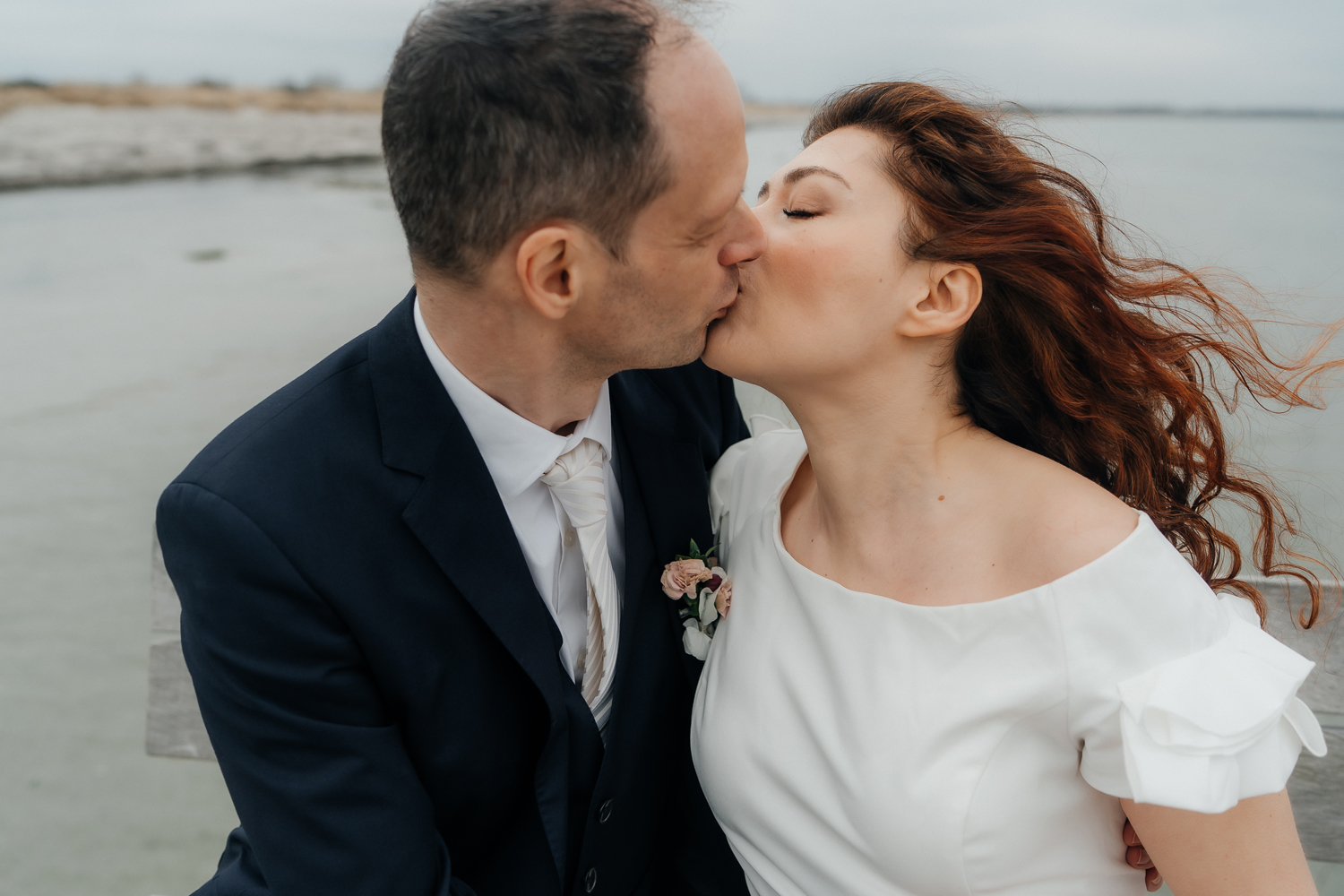 Intimate wedding at the beach in countryside of Copenhagen focused on real emotions, connection, and love. Wedding photographer in Copenhagen with a documentary style.